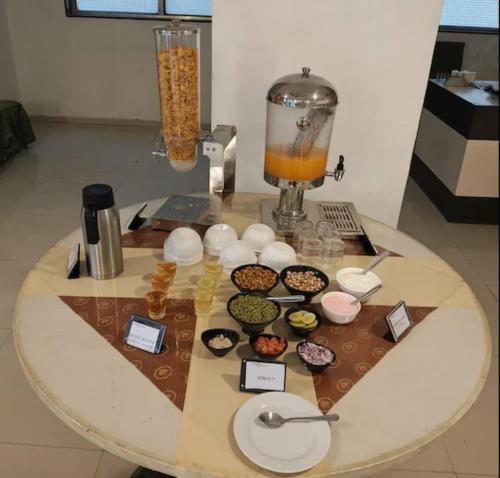 a table with some food and a blender on it at VITS Select Bharuch in Bharūch
