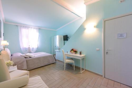 a bedroom with a bed and a desk with a table at Il Timone in Santa Margherita Ligure
