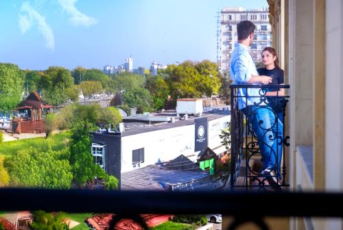 a man and a woman standing on a balcony at PC Residences Gulberg Lahore in Lahore