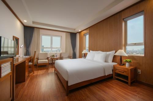 a hotel room with a bed and a television at HTOWER - 197 Văn Cao, Gia Viên, Hải Phòng in Hai Phong