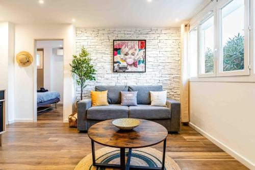 un salon avec un canapé et une table dans l'établissement Cassis le Marignan- rdc - garage - classé 3 étoiles, à Cassis