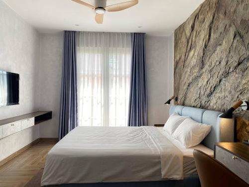 En eller flere senge i et værelse på Sandora Boutique Hotel Phu Quoc