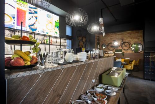 a bar with a bowl of fruit on a counter at R73 Residences in Pécs