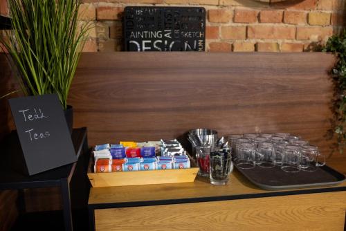 a table with drinks and glasses on a table at R73 Residences in Pécs