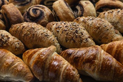 a pile of croissants and other pastries at R73 Residences in Pécs