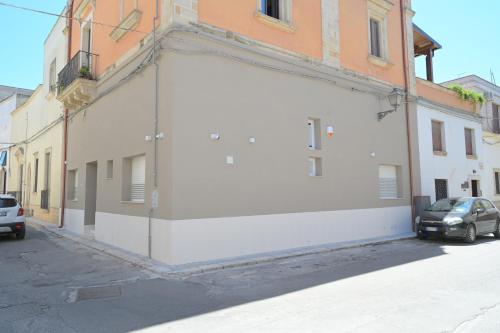 a white building on the side of a street at Casa di nonna Pina in Manduria