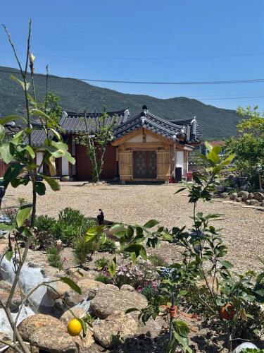 a house with a garden in front of it at Hanok Stay - JukRokJungSa in Gurye