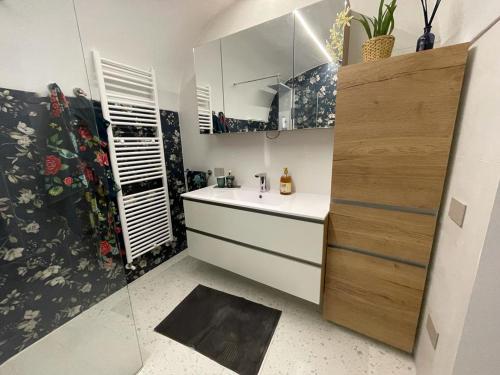 a small kitchen with a sink and a mirror at Casa di nonna Pina in Manduria