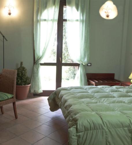 Ένα ή περισσότερα κρεβάτια σε δωμάτιο στο Agriturismo Rajata