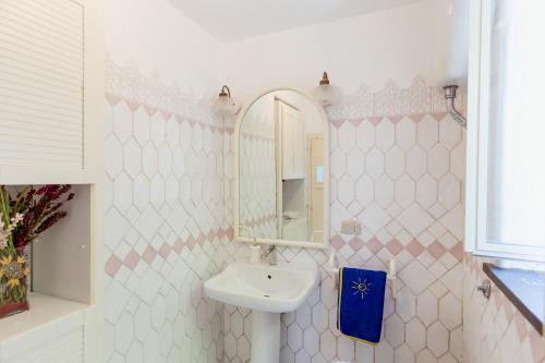 a bathroom with a sink and a mirror at La Perla Marina Suite in Capri
