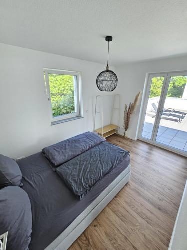 a bedroom with a bed and a pendant light at Exklusive COZY 3-Zi-Penthouse mit großer Dachterrasse Nähe Europa Park und Rulantica in Lahr