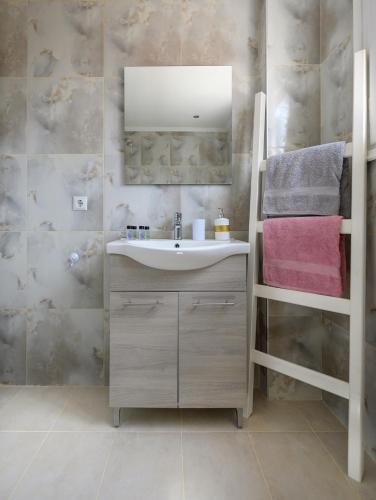a bathroom with a sink and a mirror at Seaside Villa Alexandra,Acharavi. in Acharavi
