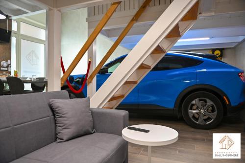 a blue car parked in a garage with a staircase at Bed and Breakfast dall'ingegnere - B&B dall'ingegnere in Foggia