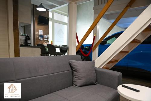 a living room with a couch and a staircase at Bed and Breakfast dall'ingegnere - B&B dall'ingegnere in Foggia