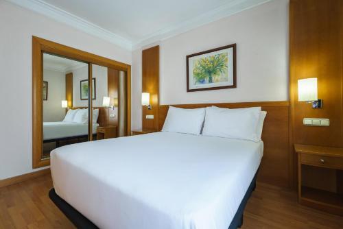 a large white bed in a hotel room at Crisol Almería in Almería
