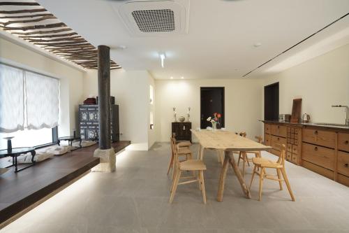 a kitchen with a table and chairs in a room at Boro Hanok Hostel in Myeongdong in Seoul