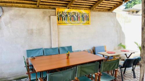 a wooden table and chairs in a patio at Maasai Hostel Tanzania in Arusha