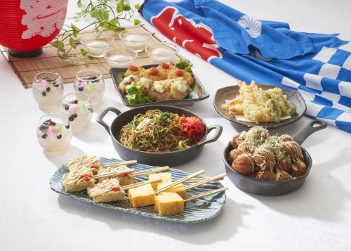 a table with four dishes of food on it at Ginza Capital Hotel Moegi in Tokyo