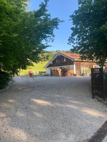 a house with a sign in front of a driveway at Ô songes de Saxel in Saxel
