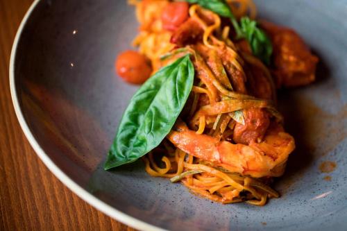 a plate of food with noodles and shrimp at The Westin Resort, Costa Navarino in Romanós