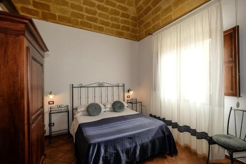 Ένα ή περισσότερα κρεβάτια σε δωμάτιο στο Ai Dammusi Rooms