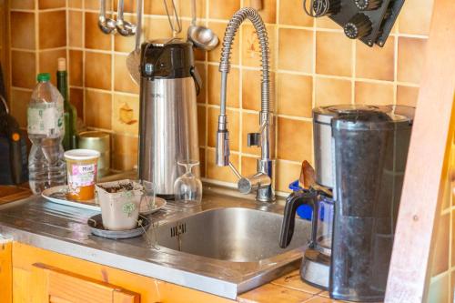 a kitchen counter with a sink in a kitchen at La ferme de séjour du Cosquer in Beuzec-Cap-Sizun