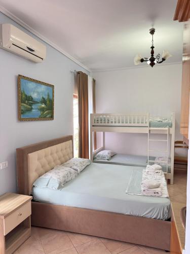 a bedroom with two beds and a bunk bed at Garden Villa Veli in Ksamil