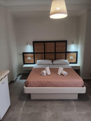 a bedroom with a large bed with two pillows on it at Petra Nera in Perissa