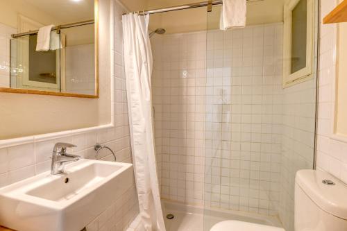 a bathroom with a sink and a shower at Penyagolosa in Calella de Palafrugell