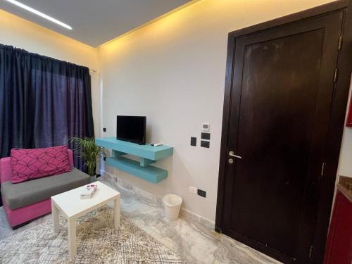 a living room with a couch and a table at Studio beverly hills premium sheikh Zayed in Sheikh Zayed