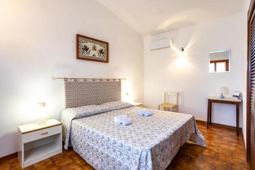 a bedroom with a bed with two towels on it at Villa Alba in Costa Paradiso