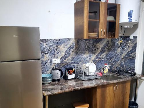 a kitchen with a sink and a refrigerator at Central House in Kutaisi