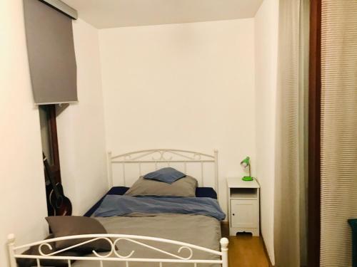 a bedroom with a bed in a white room at Vintage Studio Apartment in Klagenfurt