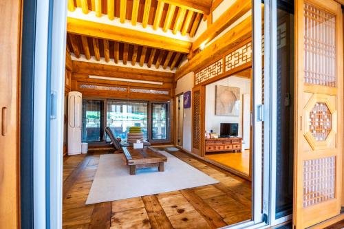 a living room with a bench and a table at Hanok Stay - JukRokJungSa in Gurye