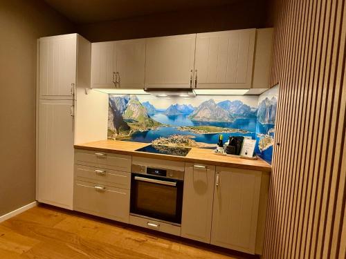 a kitchen with a painting on the wall at Apartment Fjordliebe, Lammplatz Bad Krozingen in Bad Krozingen