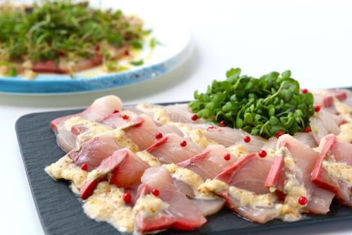 a plate of food with meat and a plate of greens at Premier hotel -CABIN PRESIDENT- Tokyo in Tokyo