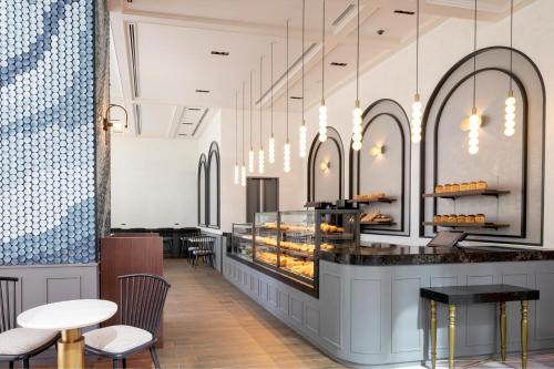 a bakery with a counter and chairs and tables at Premier hotel -CABIN PRESIDENT- Tokyo in Tokyo