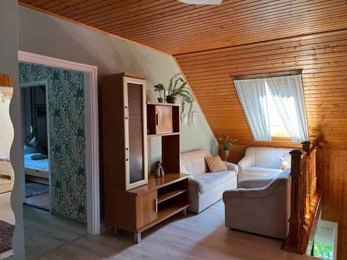 a living room with a couch and a mirror at Holiday home in Gyenesdias - Balaton 40755 in Gyenesdiás
