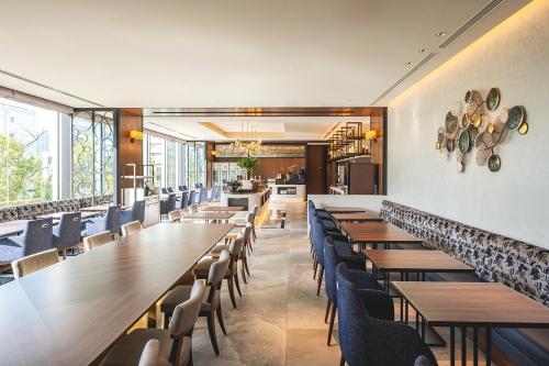 a dining room with wooden tables and chairs at Premier hotel -CABIN PRESIDENT- Tokyo in Tokyo