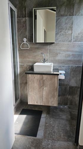 a bathroom with a sink and a mirror at CasaMari guesthouse in Pretoria