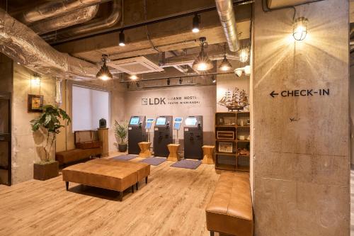 a large room with a lobby with a table and chairs at GRAND HOSTEL LDK Tokyo Nishikasai -GRAND OPENING In May 2025- in Tokyo