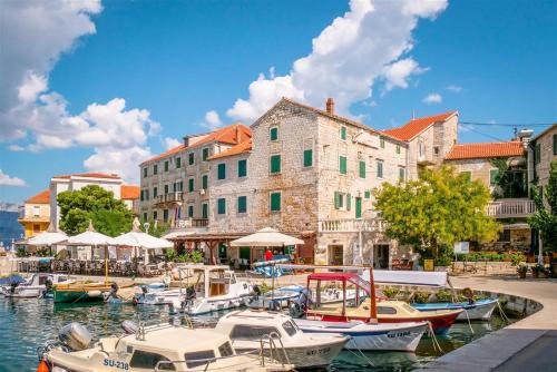a group of boats are docked in a harbor at Apartmani Banić Apartman 5 in Postira