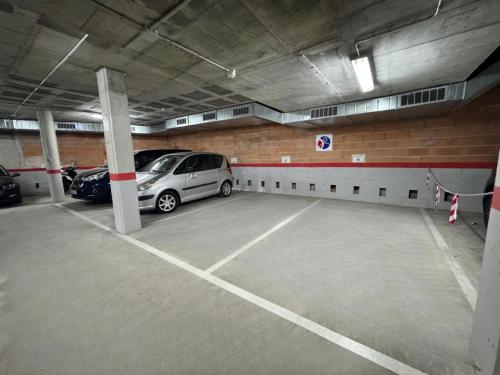 a parking garage with two cars parked in it at "Breeze" Aparthotel by Parrot`s House in Lloret de Mar