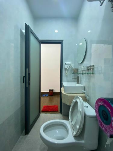 a bathroom with a toilet and a sink at Winston Hotel Riverside in Ho Chi Minh City
