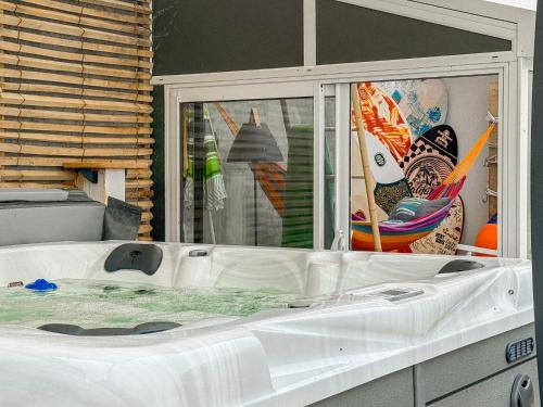 a large white bath tub sitting in a room at maison au calme la chaume 6 personnes in La Chaume