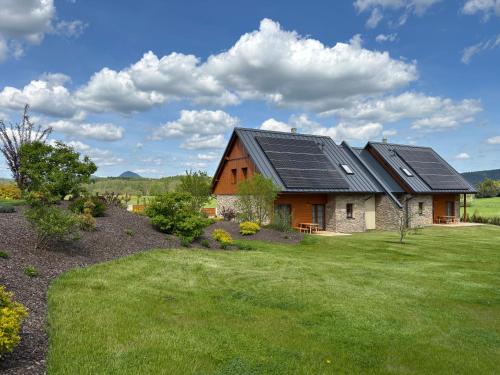 a house with solar panels on the roof at Pihel Apartments in Nový Bor