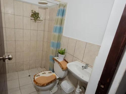 un baño con inodoro y lavabo en Fully furnished 3-Bedroom Apt In Tarapoto, en Tarapoto
