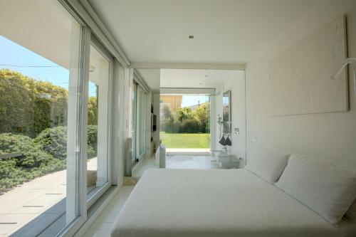 a bedroom with a large bed and a large window at Italian Experience-Villa Rosa Del Mare in Marzocca di Senigallia