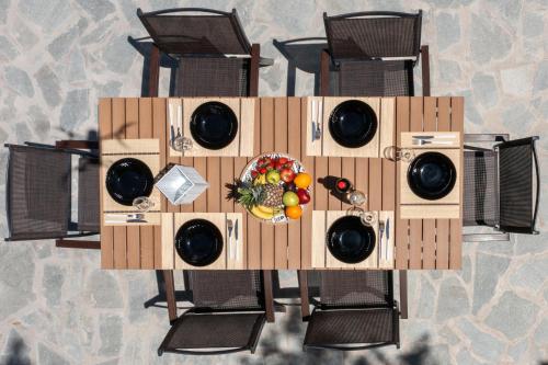 a table with a plate of fruit on it at AGGELLE Villa in Potamós