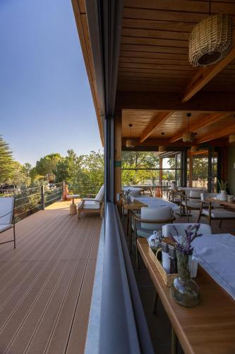 a restaurant with tables and chairs on a deck at Ida Trio in Edremit